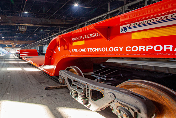 Heavy-haul flatcar on railroad tracks for industrial freight transport