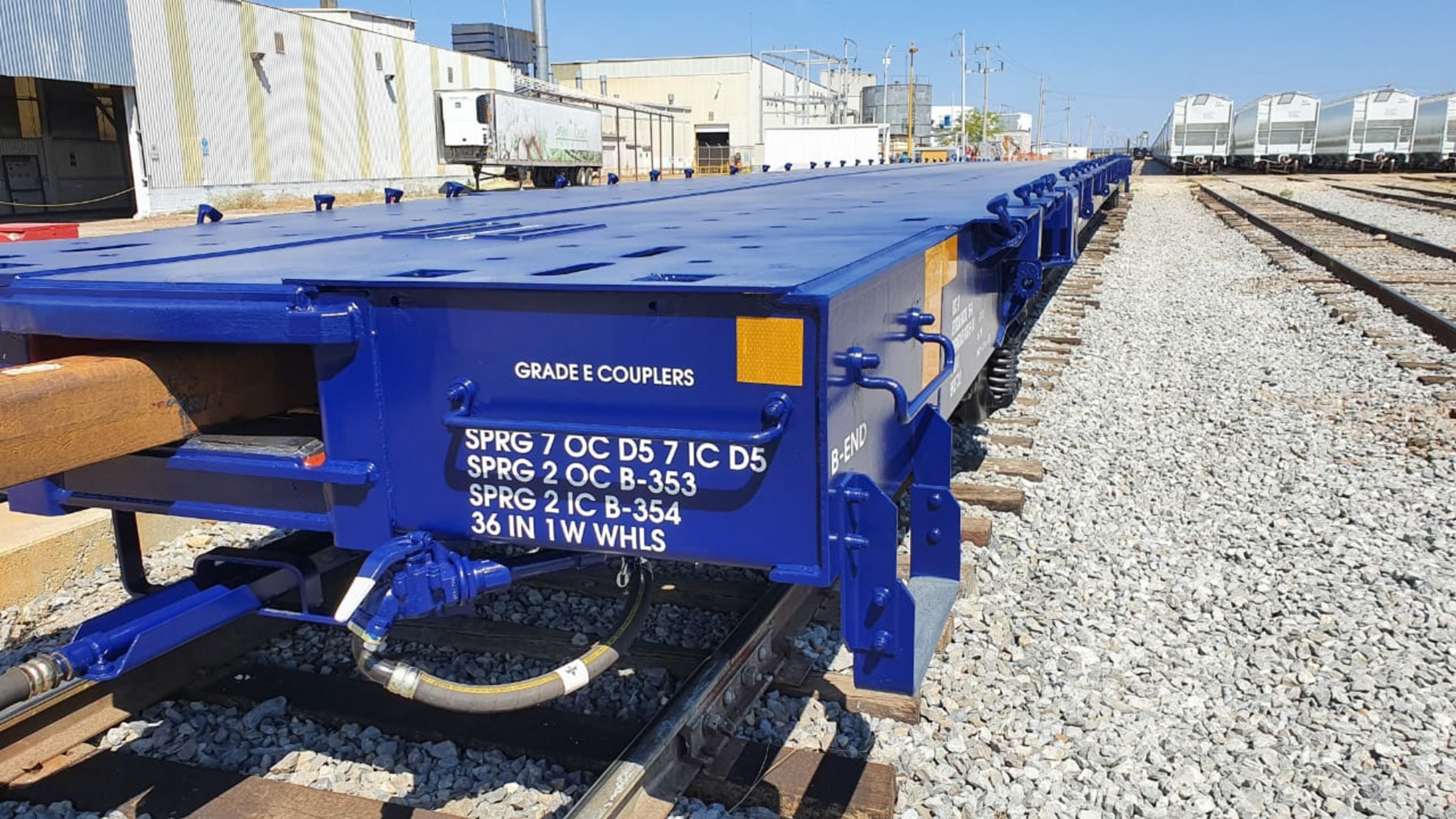 Remanufactured blue flatcar with Grade E couplers and technical specifications