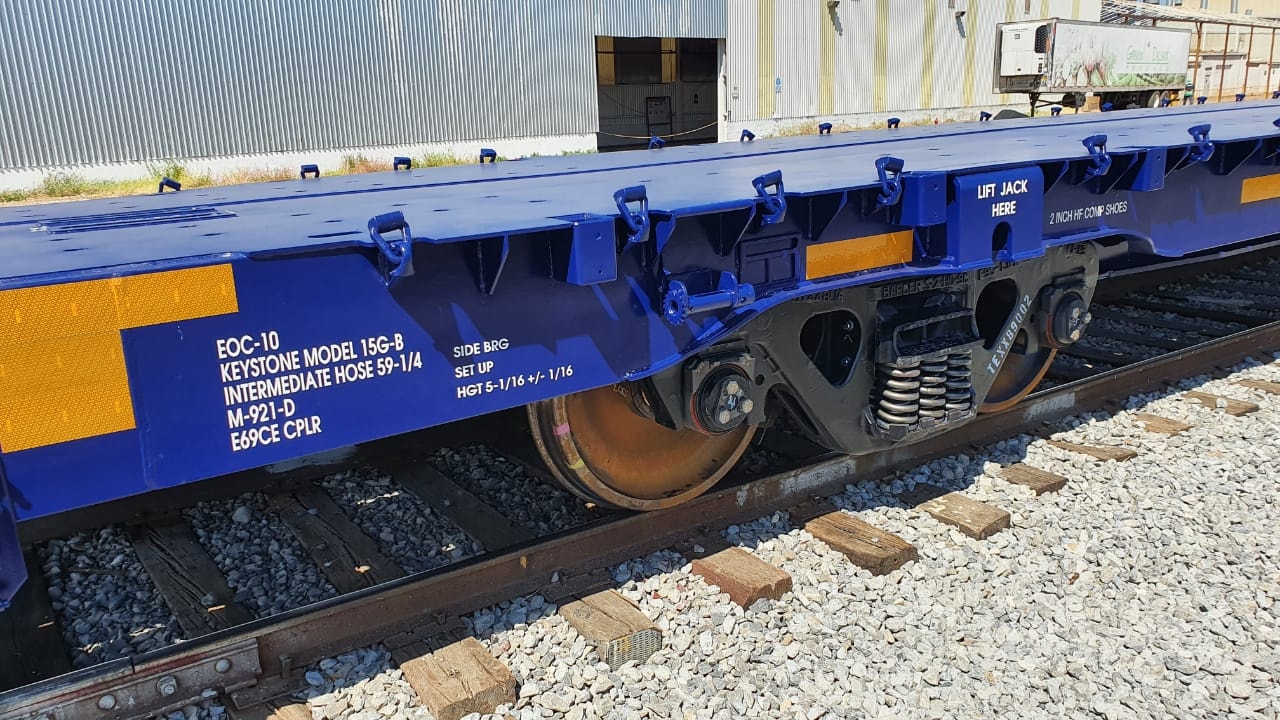 Remanufactured blue flatcar undercarriage detail showing Keystone Model 15G-B trucks